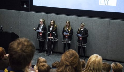 a group of people standing in front of a television