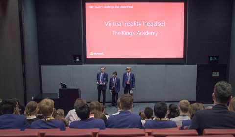 a group of people watching a screen