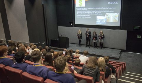 a group of people sitting in front of a television