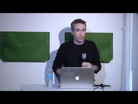 a man standing in front of a laptop