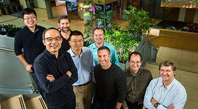 Microsoft researchers from the Speech & Dialogue research group include, from back left, Wayne Xiong, Geoffrey Zweig, Xuedong Huang, Dong Yu, Frank Seide, Mike Seltzer, Jasha Droppo and Andreas Stolcke. (Photo by Dan DeLong)