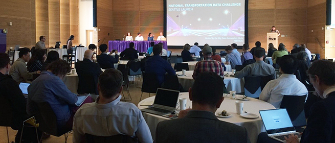 a group of people sitting at a table in front of a crowd