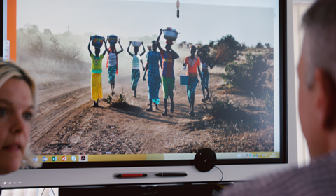 a group of people in front of a computer screen