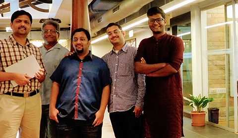 a person standing in front of a group of people posing for the camera