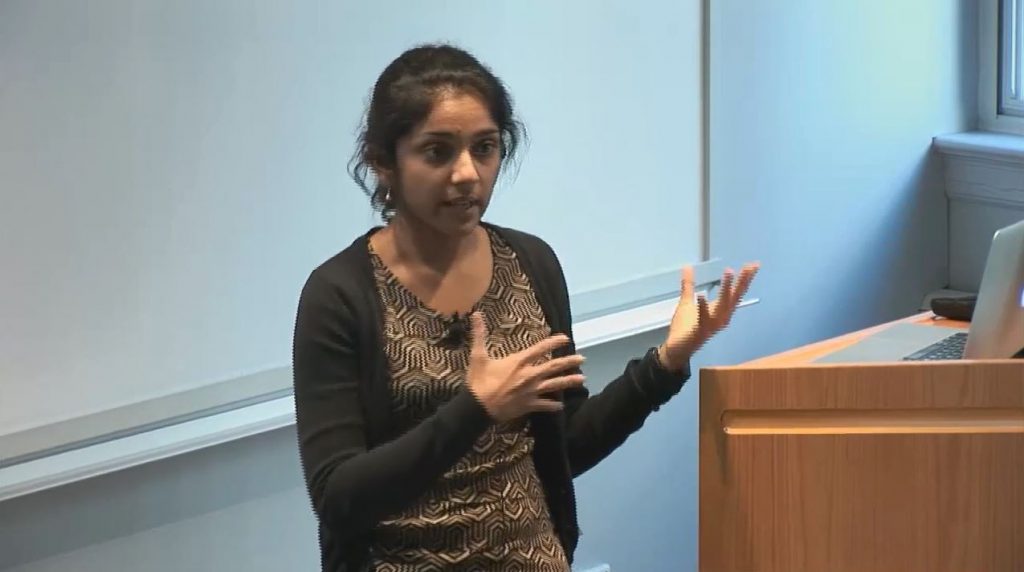 a woman standing in front of a mirror posing for the camera