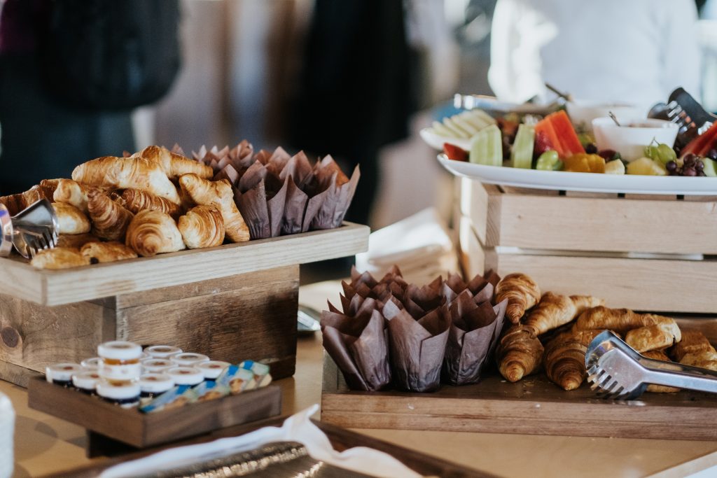 a bunch of hot dogs with different toppings sitting on a table