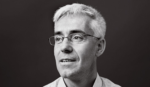 a man wearing glasses and looking at the camera