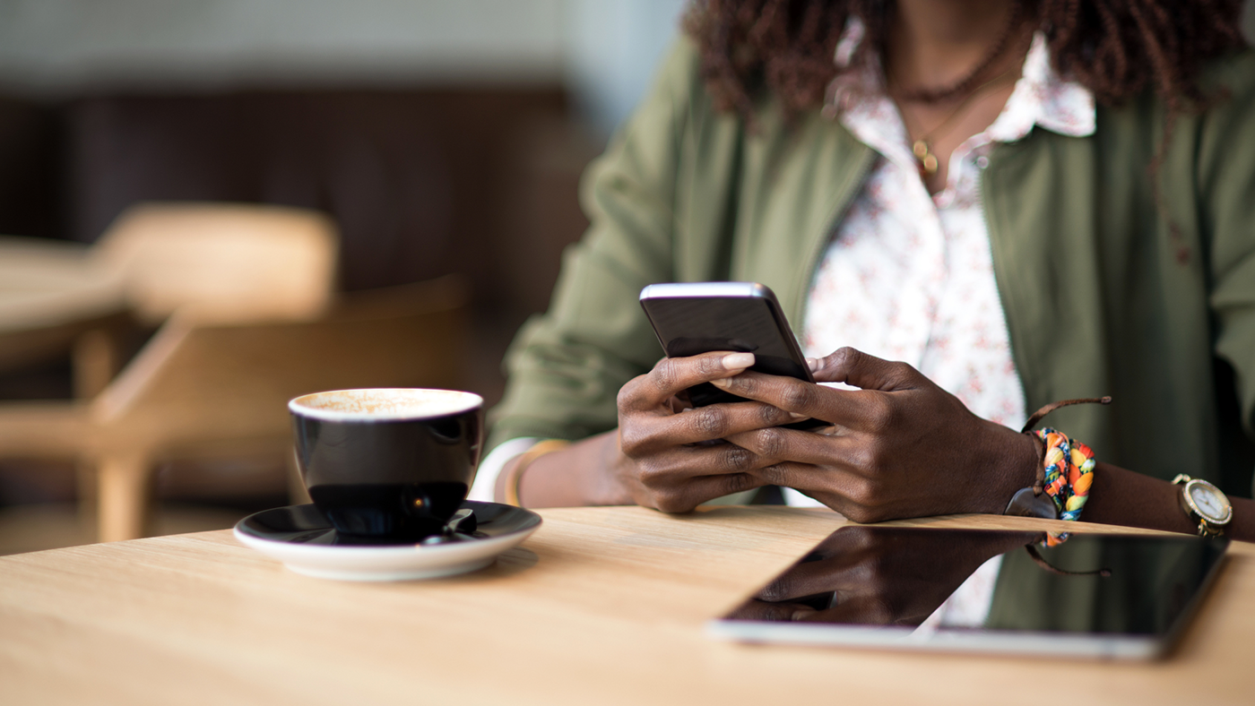 a person sitting at a table using a laptop computer