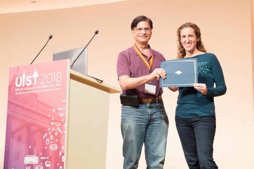 Meredith Morris holding a sign posing for the camera