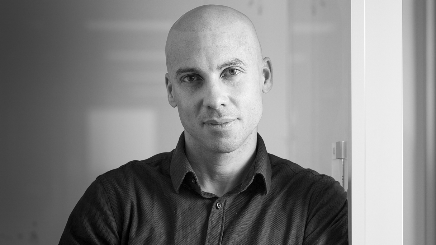 a man wearing glasses posing for the camera