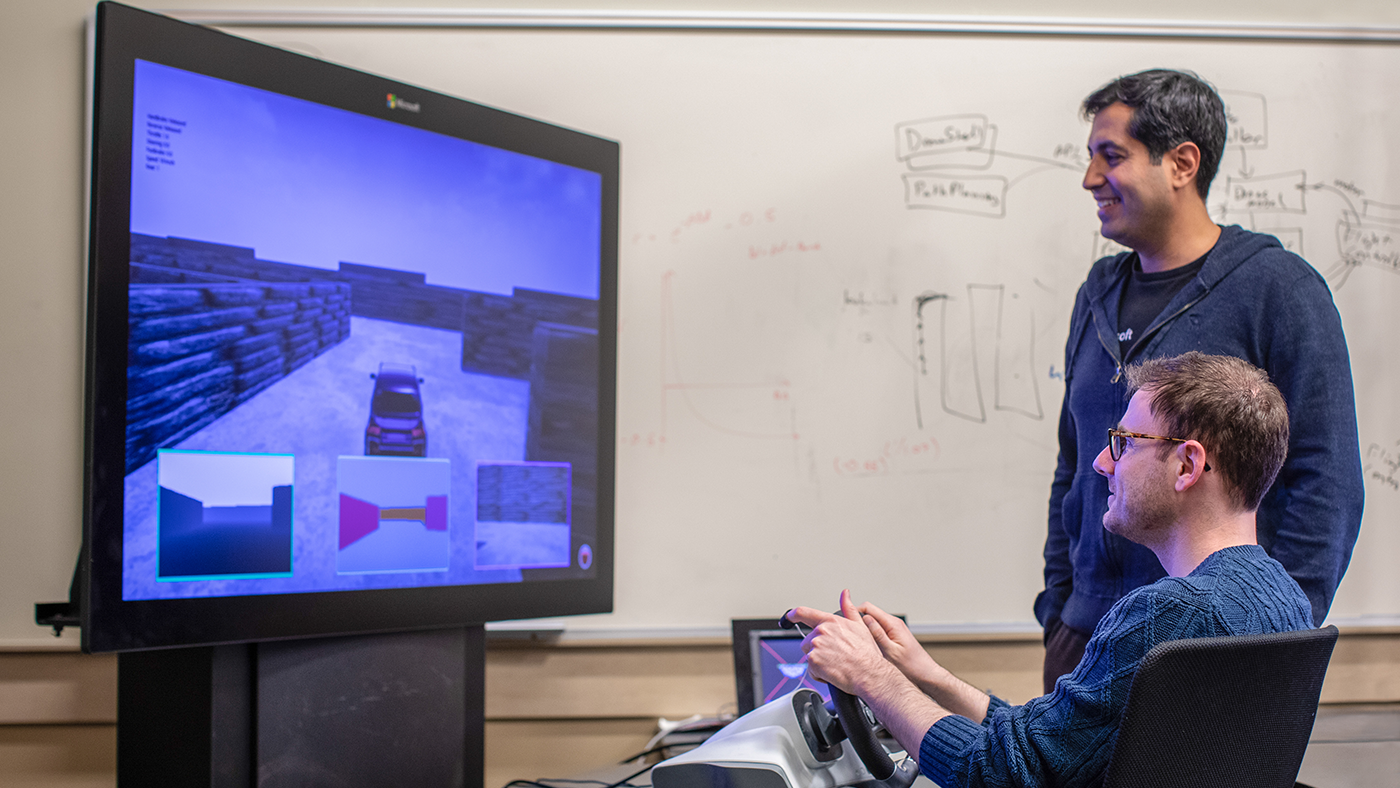 a man standing in front of a computer screen