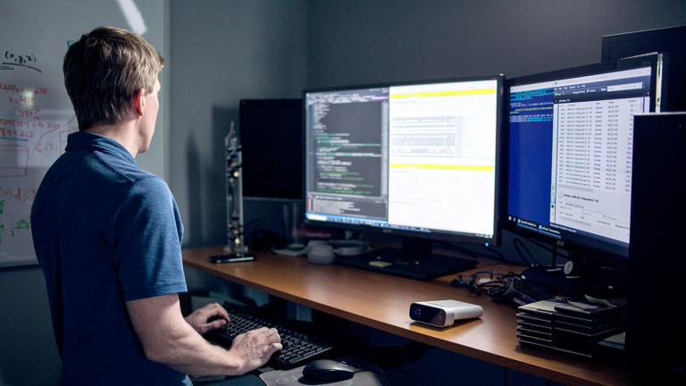 Person on computer with multiple screens