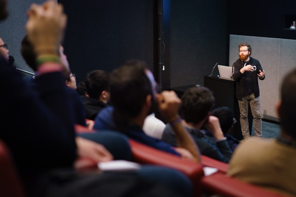 a group of people sitting in front of a crowd