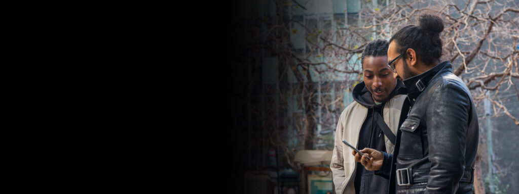 two men viewing personalized news on a cellphone