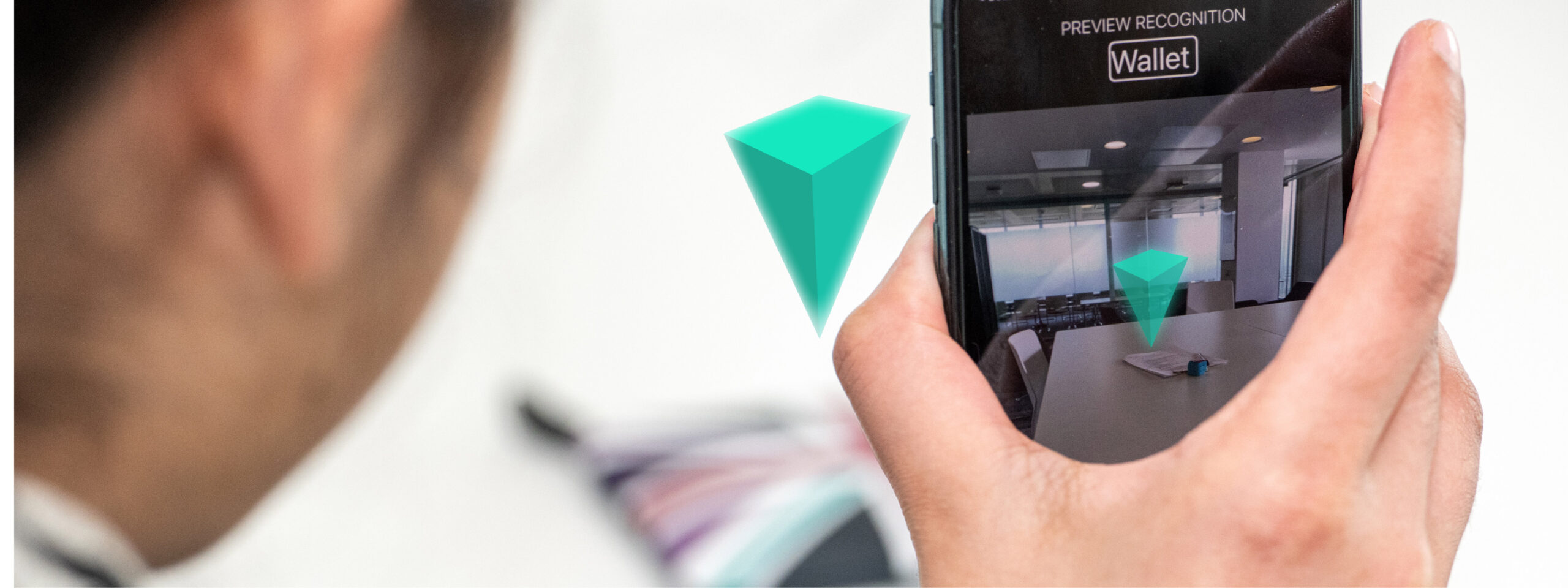 A man holding a smartphone using Teachable AI Experiences (Tai X) technology