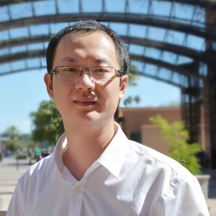 a person wearing glasses and smiling at the camera