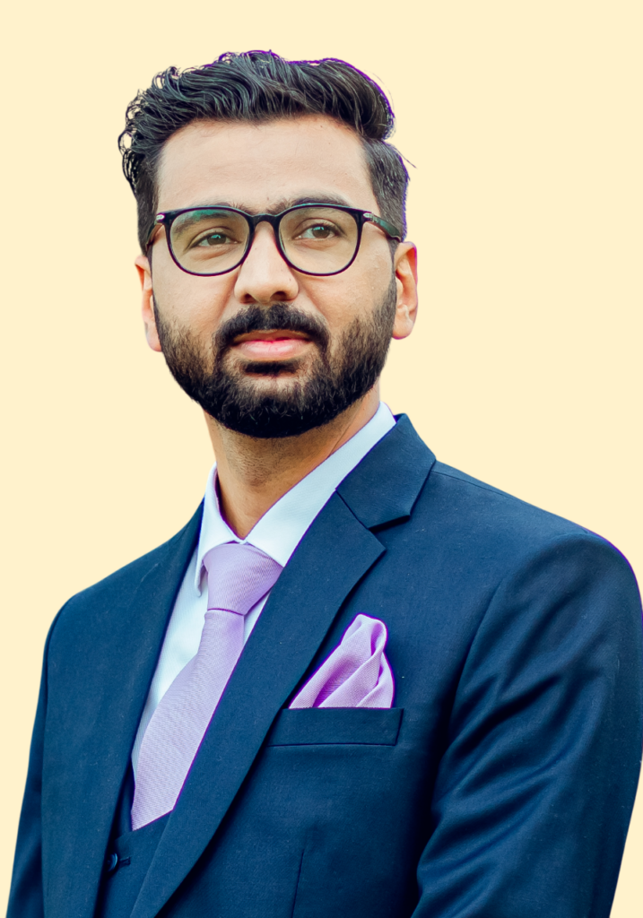 a man wearing glasses and a suit