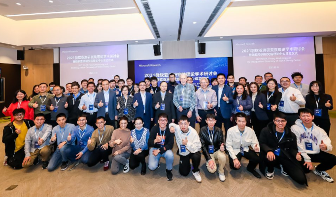 a group of people standing in front of a crowd posing for the camera