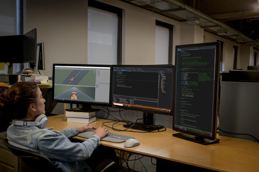 a person sitting at a desk with a computer monitor