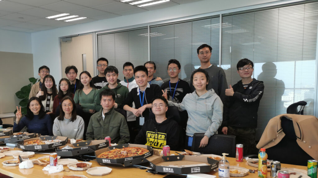 a group of people sitting at a table posing for the camera