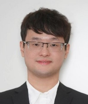 a man wearing a suit and tie smiling at the camera