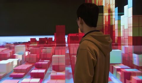 man standing and looking at a digital scene