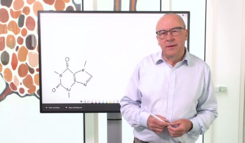 Christopher Bishop standing in front of a whiteboard