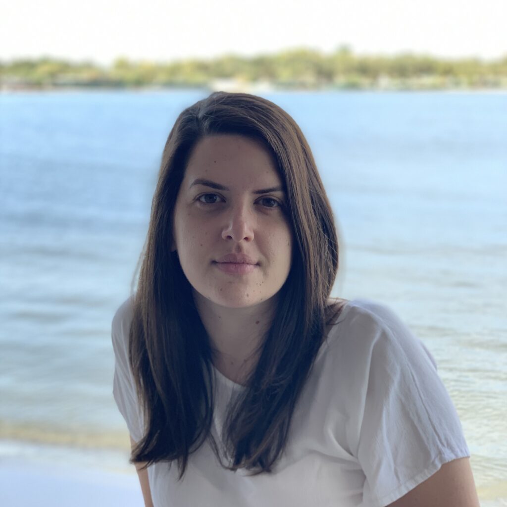a person standing in front of a body of water