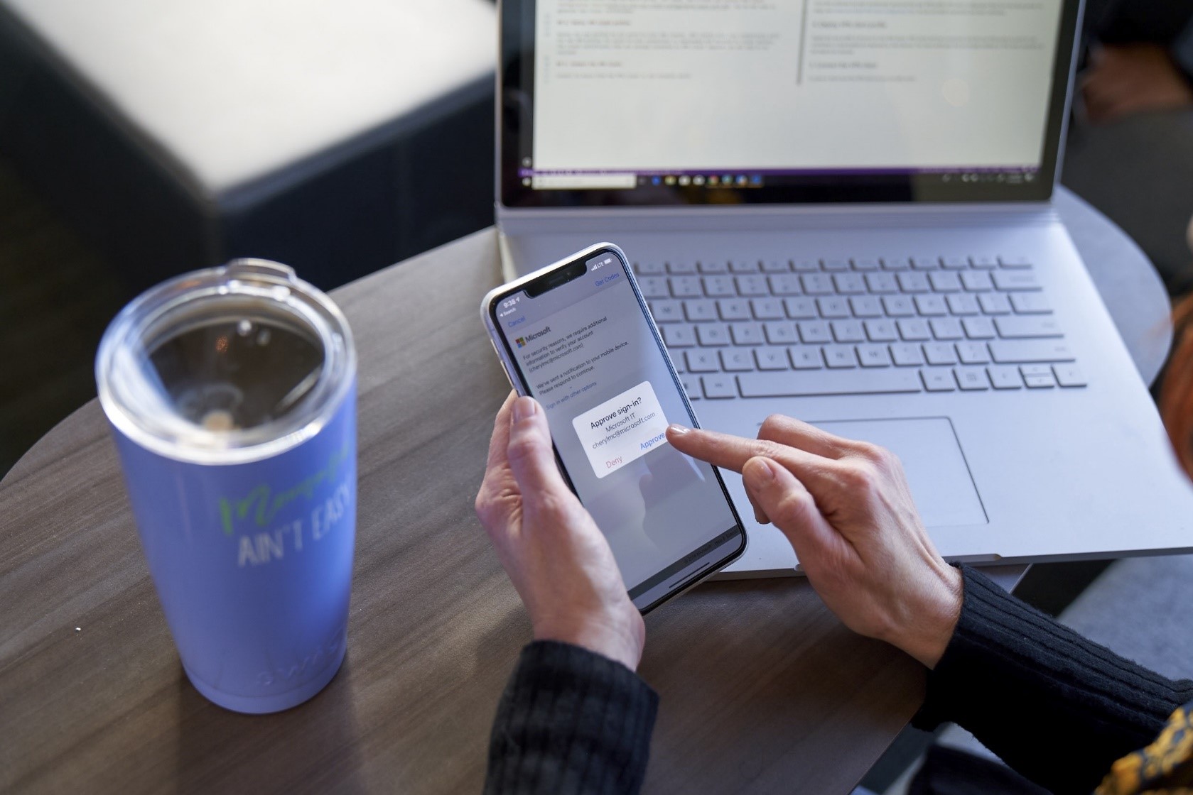 Image of a worker approving a sign-in from his phone.