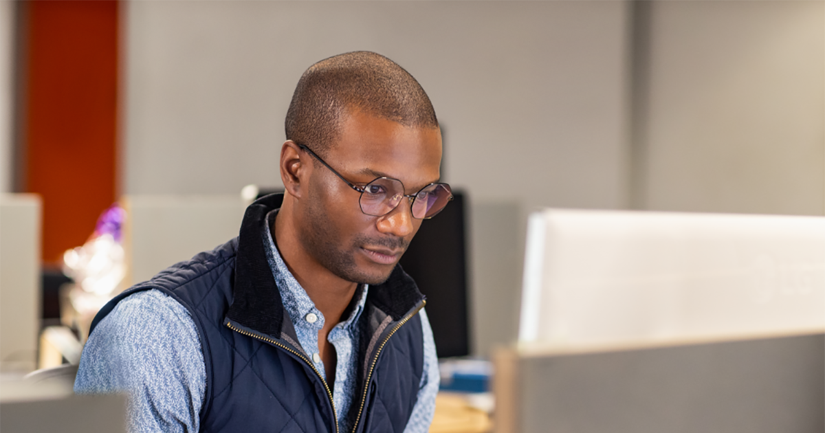 An image of a black male developer at work in an Enterprise office workspace.