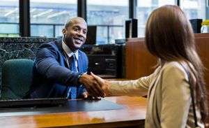 Image of a banking professional shaking hands with a customer.