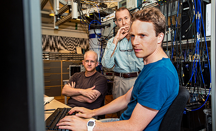 A group of tech workers checking out some suspicious code.