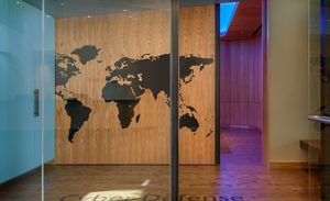 Image of an office hallway with a map of the world carved into it.