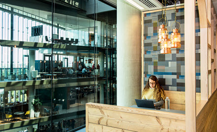Image of a worker in a booth in a cafeteria.
