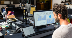 Image of a man working at his desktop PC.