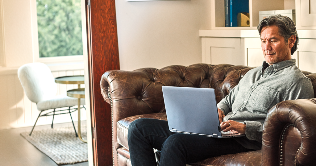 Man interacting with a Leno Yoga laptop.