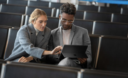 Contextual image of man and woman collaborating while working on Surface Pro6