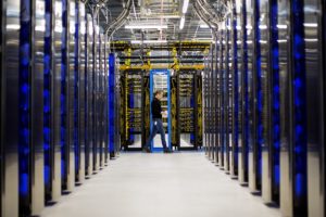 man standing at the end of a datacenter