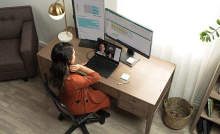 A woman having a Microsoft Teams in her living room home office on her Acer TravelMate P6.