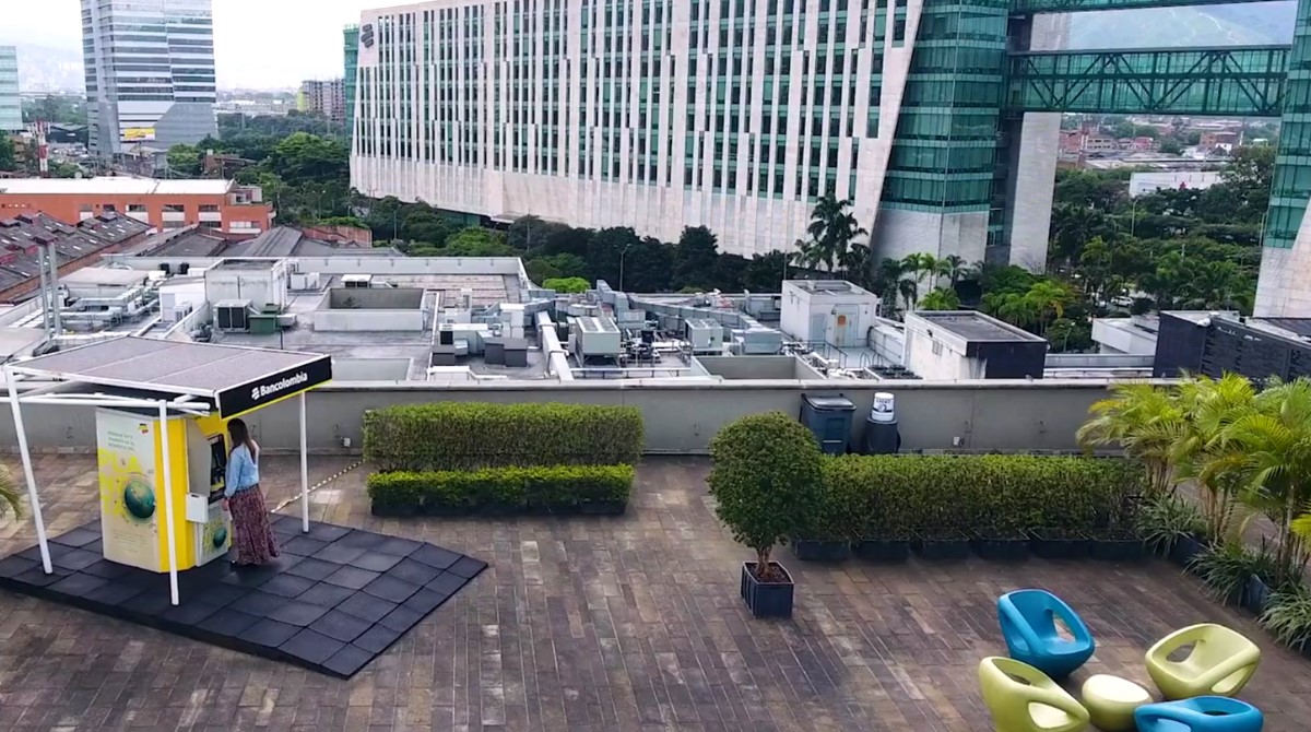 Aerial view of customer using a Bancolumbia ATM.