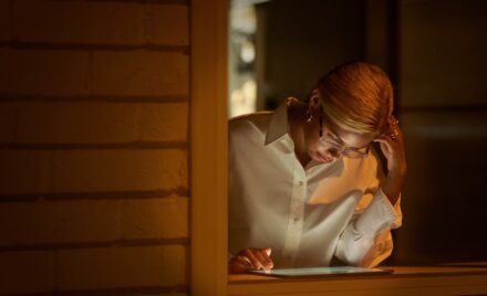Retail store manager using a tablet securely while working remote from a café.