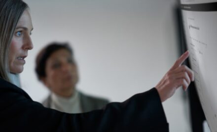 Chief information security officer collaborating with a practitioner in a security operations center.