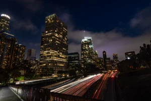 Photograph of time-lapse of nighttime traffic around a city core​