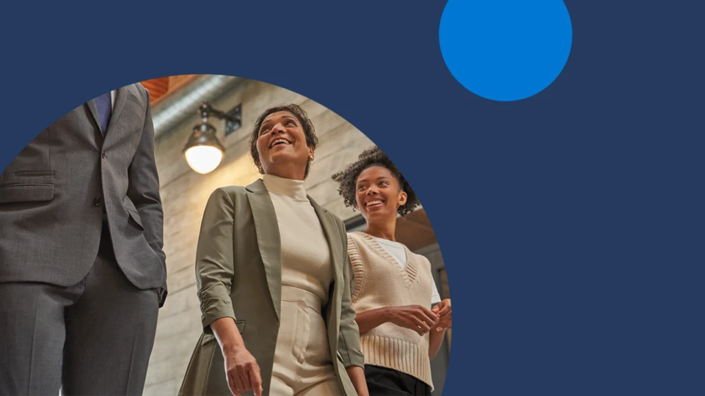 Three business decision makers walking down a hallway.