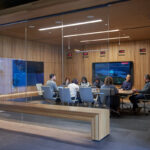 a conference room of people sitting around a table