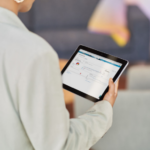 A woman looks at a tablet.