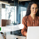 Woman working on a laptop.