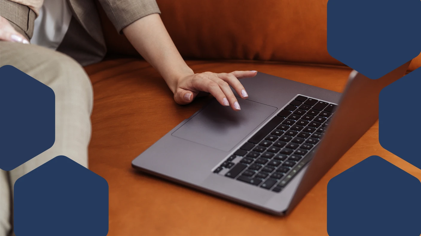 Person sitting on a couch using a laptop.