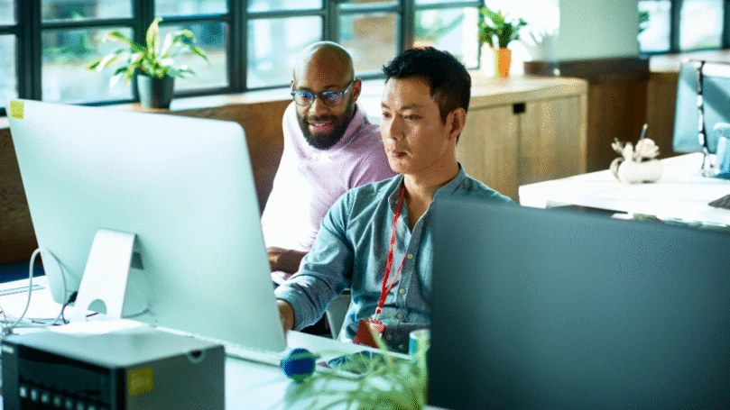 Two colleagues collaborating at a desk.
