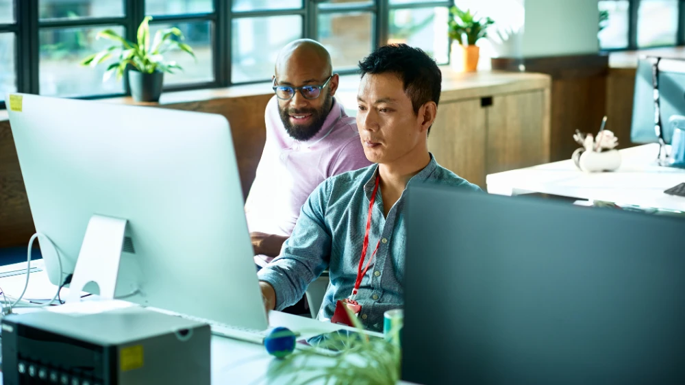 Two colleagues collaborating at a desk.
